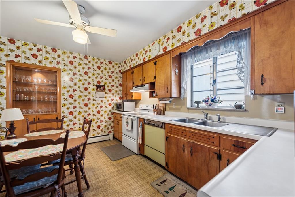 340 Weldon Street Latrobe, PA 15650 - Photo 9 of 26 a kitchen with sink cabinets and window
