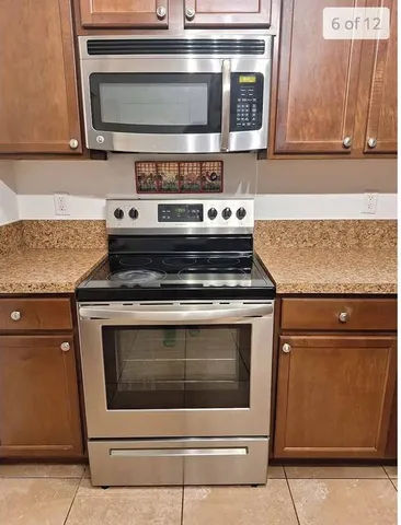 a stove top oven sitting inside of a kitchen