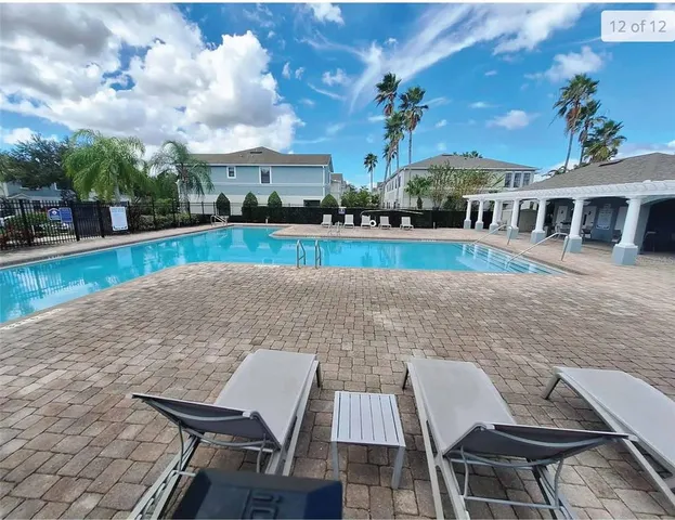 a view of house with yard and seating