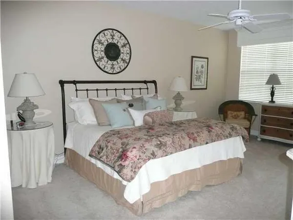 a bedroom with a bed mirror and a window