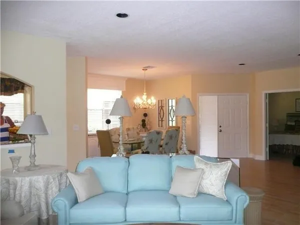 a living room with furniture and a large mirror