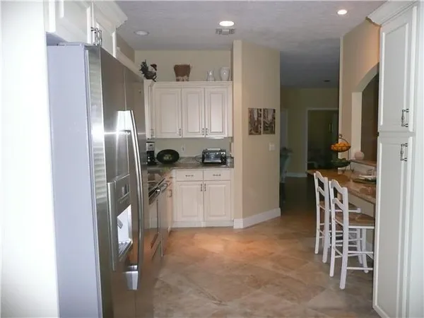 a kitchen with a refrigerator and cabinets