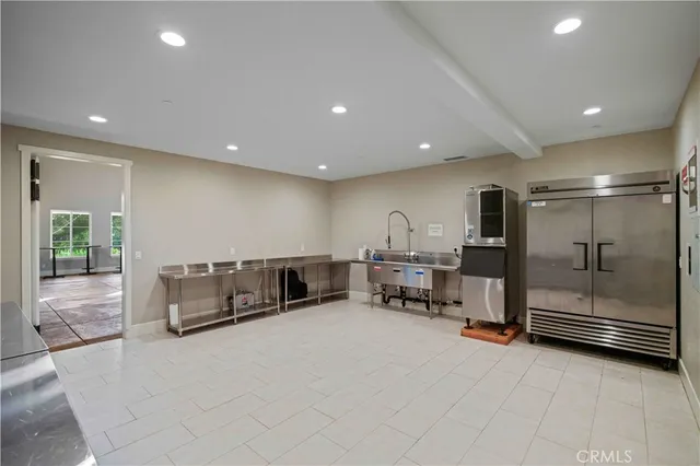 a large room with gym equipment and mirrors