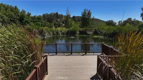 a view of balcony with wooden floor and lake view