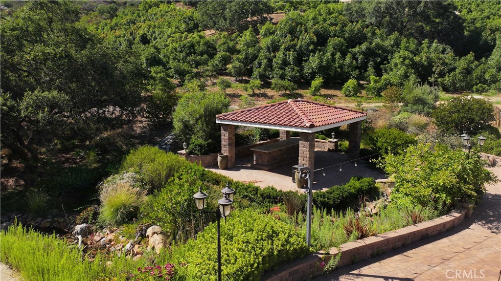 38149 De Luz Road Fallbrook, CA 92028 - Photo 21 of 36 a view of a patio with table and chairs under an umbrella