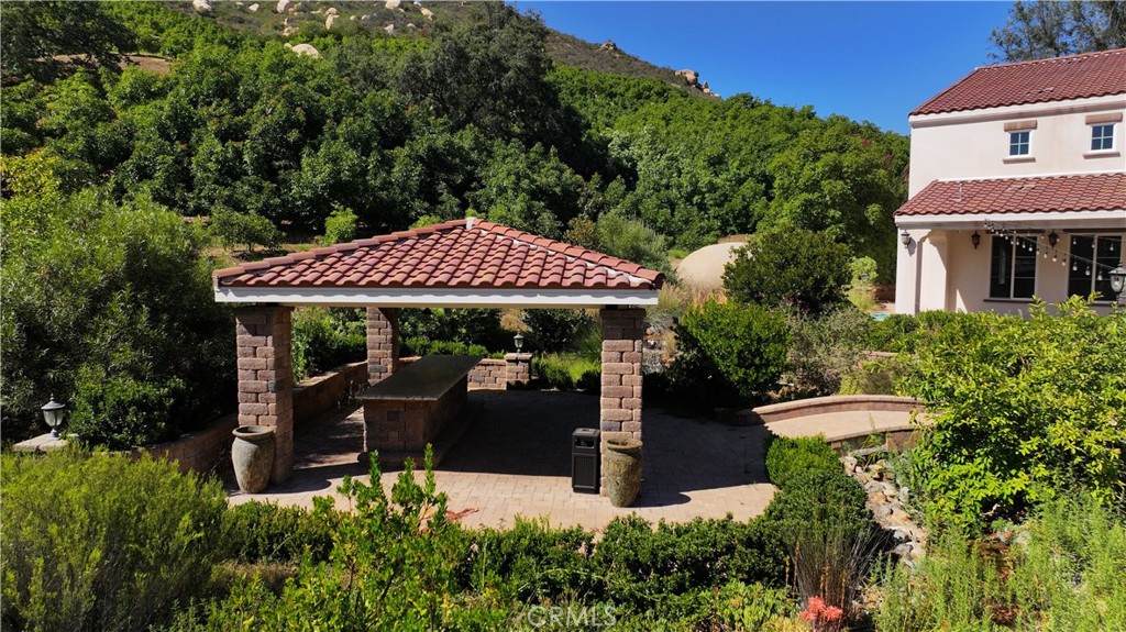 38149 De Luz Road Fallbrook, CA 92028 - Photo 22 of 36 a view of a patio with table and chairs under an umbrella
