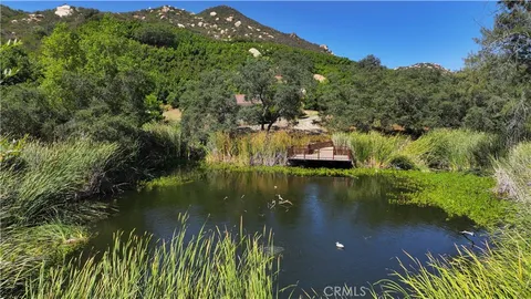 a view of a lake with a house in the background