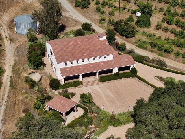 an aerial view of a house with a yard