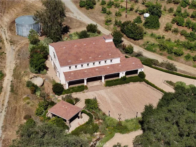 an aerial view of a house with a yard
