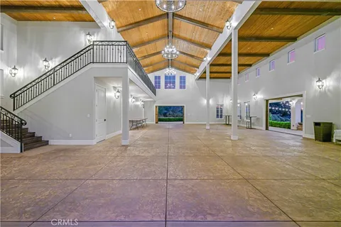 a view of a hall with stairs and a fireplace