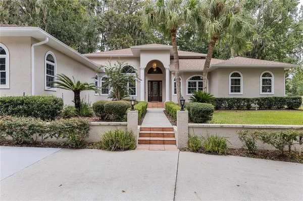 a front view of a house with a garden