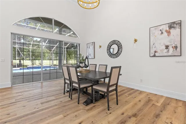 a living room with furniture a large window and a chandelier
