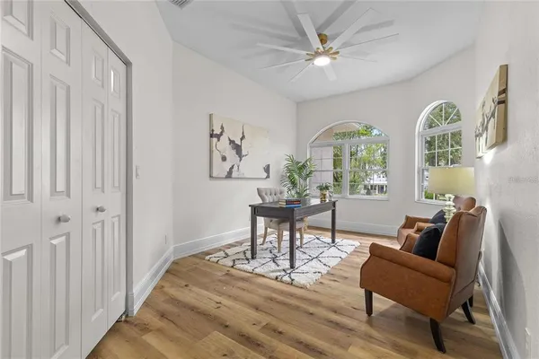 a living room with furniture and a potted plant