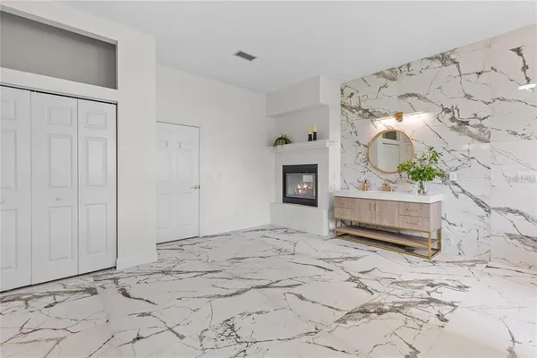 a spacious bathroom with a sink mirror and a bathtub