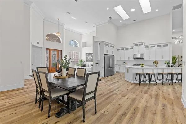 a view of a dining room with furniture and a chandelier