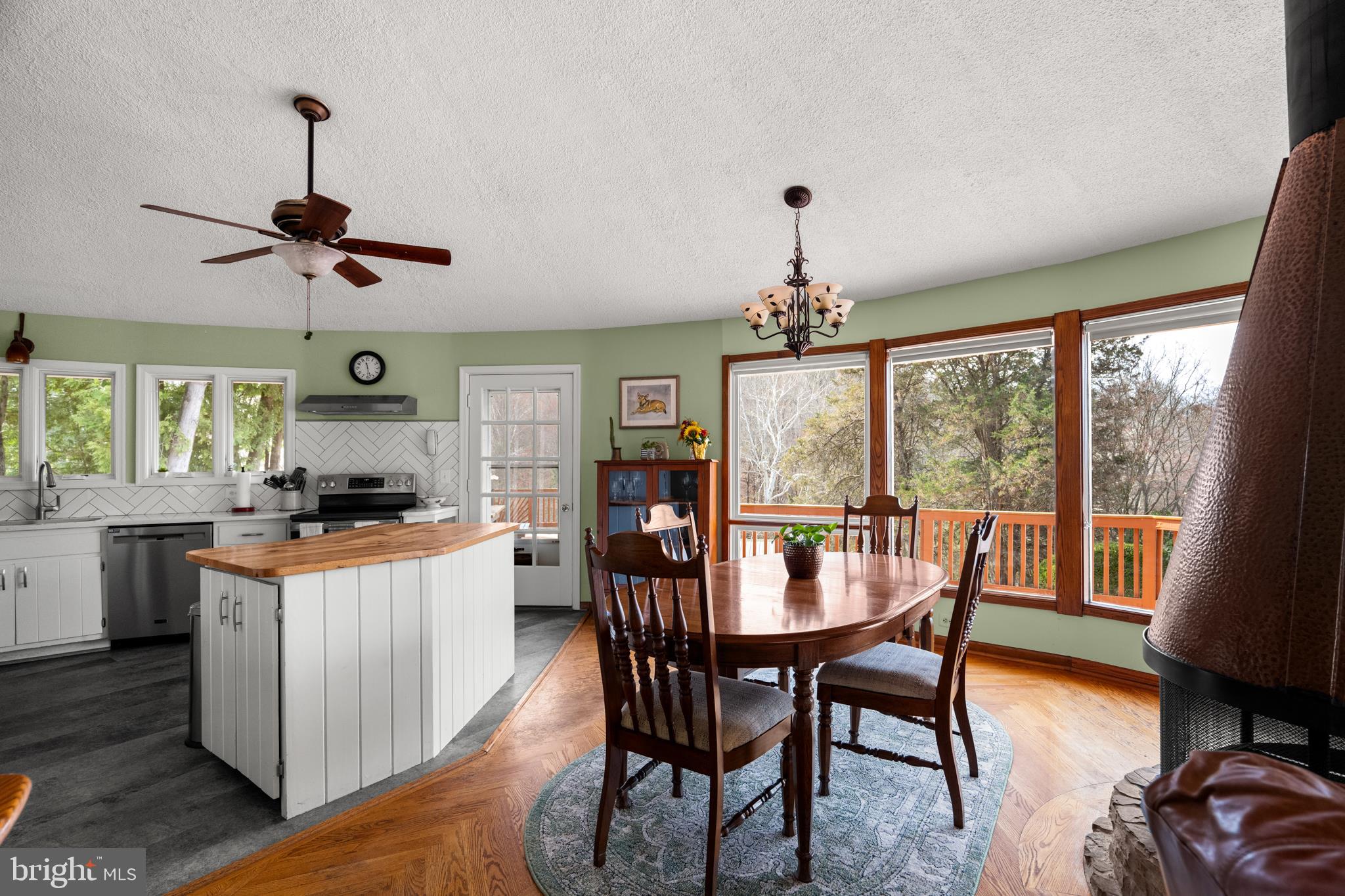 10803 Crest Hill Road Marshall, VA 20115 - Photo 7 of 30 a kitchen with stainless steel appliances granite countertop a stove a refrigerator a kitchen island a table and chairs in it