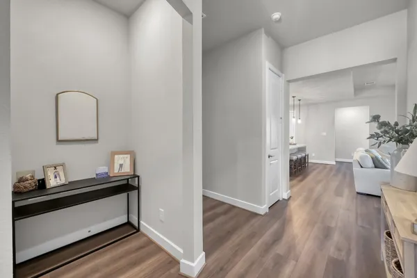 a view of a hallway view with wooden floor and staircase