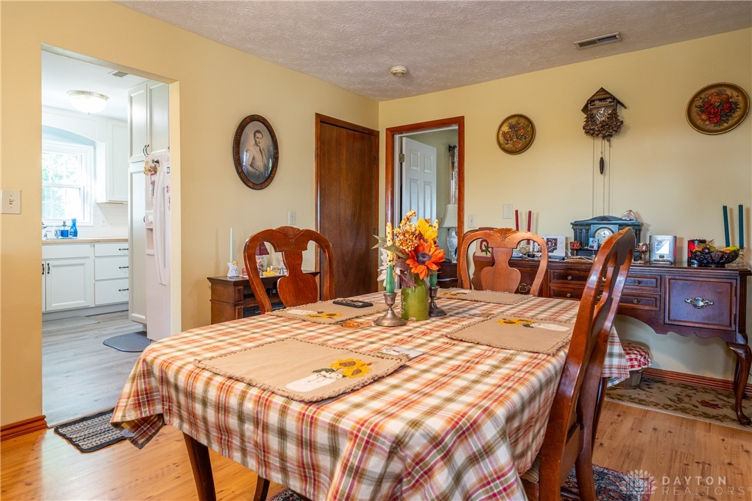 1599 Garringer Road Jamestown, OH 45335 - Photo 10 of 73 This cozy dining area features warm tones and leads to a bright, functional kitchen.
