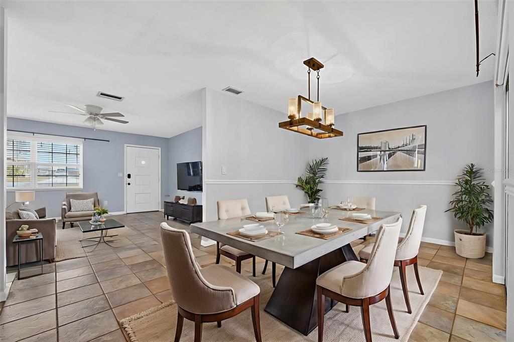309 North 8th Street Dundee, FL 33838 - Photo 11 of 91 a dining room with furniture a chandelier and wooden floor