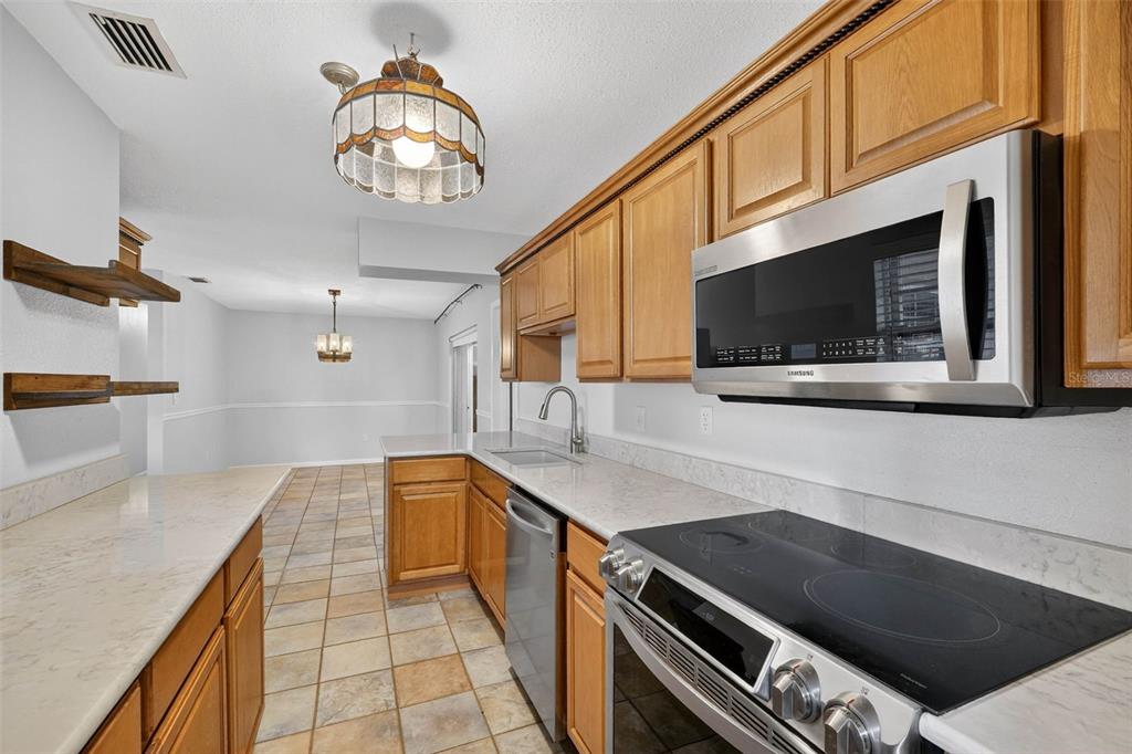 309 North 8th Street Dundee, FL 33838 - Photo 20 of 91 a kitchen with stainless steel appliances granite countertop a sink and a stove