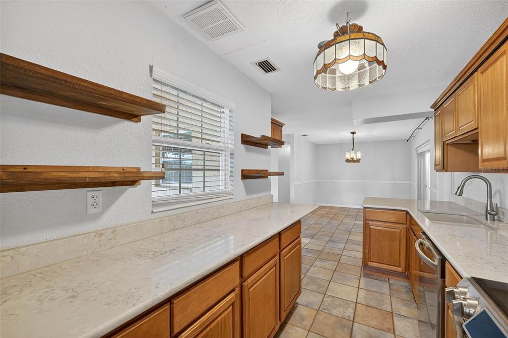 309 North 8th Street Dundee, FL 33838 - Photo 21 of 91 a kitchen with stainless steel appliances granite countertop a sink and dishwasher