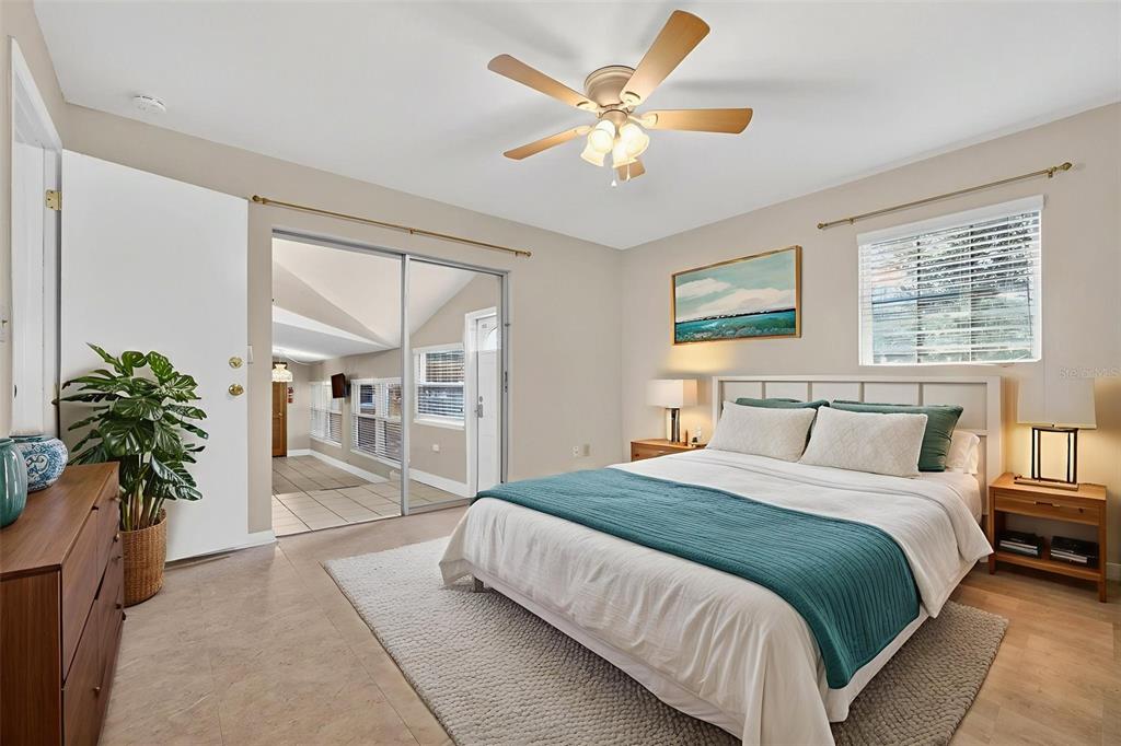 309 North 8th Street Dundee, FL 33838 - Photo 31 of 91 a spacious bedroom with a balcony a bed and a chandelier