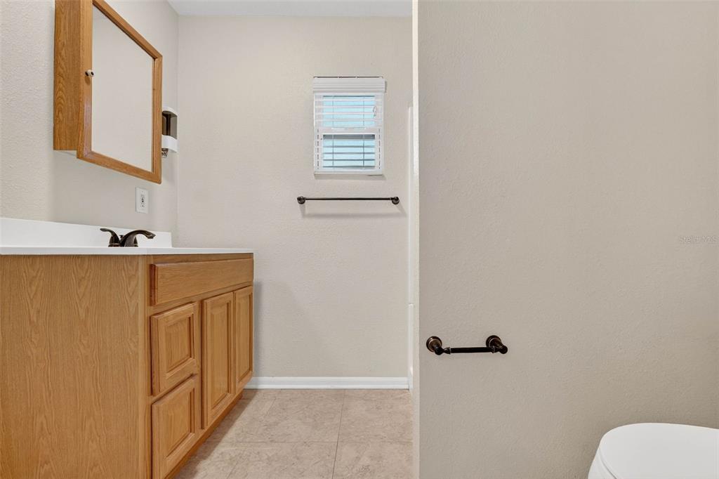 309 North 8th Street Dundee, FL 33838 - Photo 38 of 91 a bathroom with a sink a toilet and shower