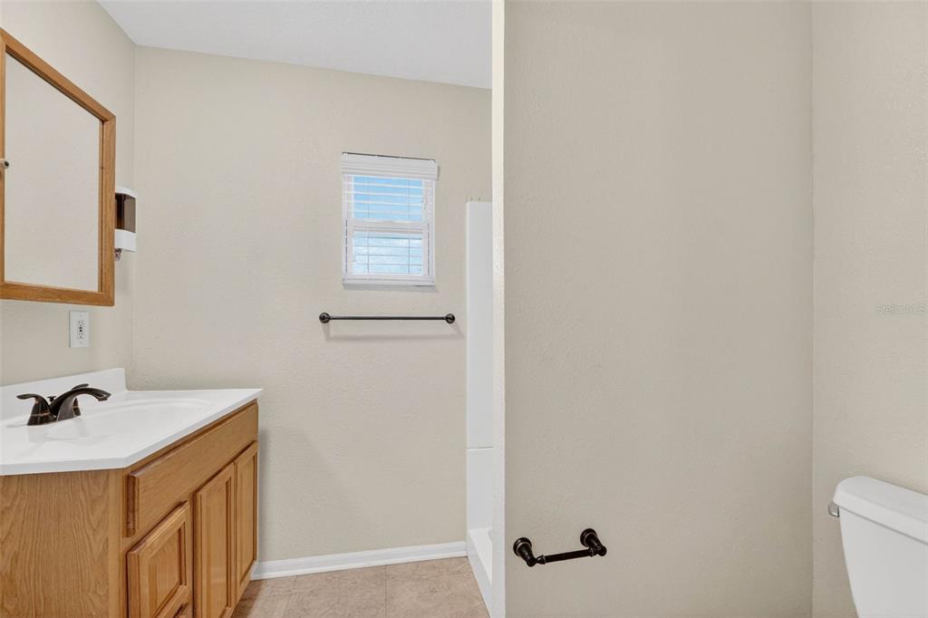 309 North 8th Street Dundee, FL 33838 - Photo 43 of 91 a bathroom with a sink a toilet and mirror