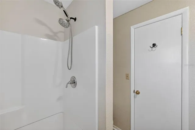 a view of a big room with windows and entryway