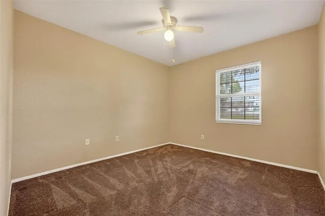 an aerial view of residential house with outdoor space and trees all around