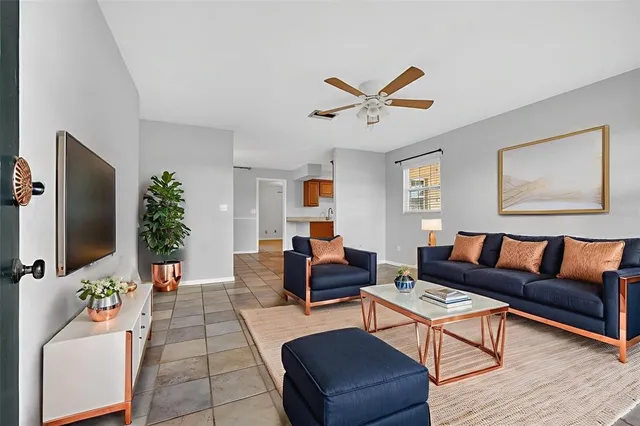 an empty room with windows and fan