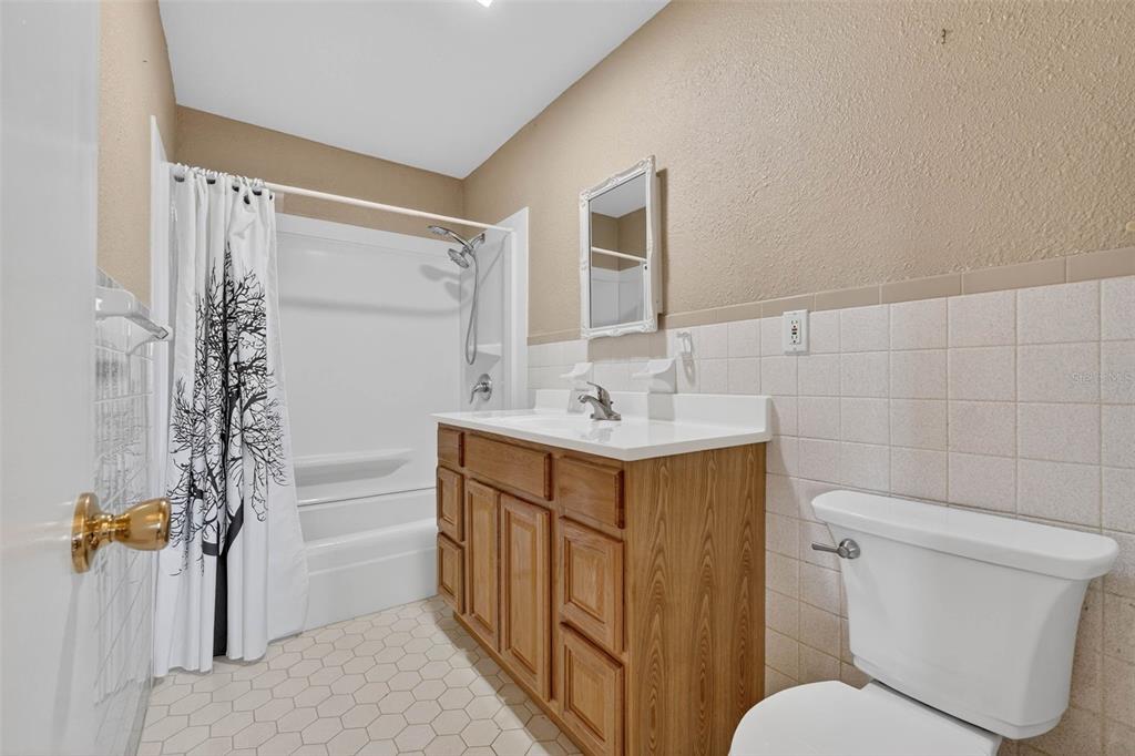 309 North 8th Street Dundee, FL 33838 - Photo 52 of 91 a bathroom with a sink mirror vanity and toilet