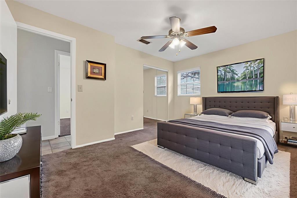 309 North 8th Street Dundee, FL 33838 - Photo 54 of 91 a spacious bedroom with a bed and a potted plant