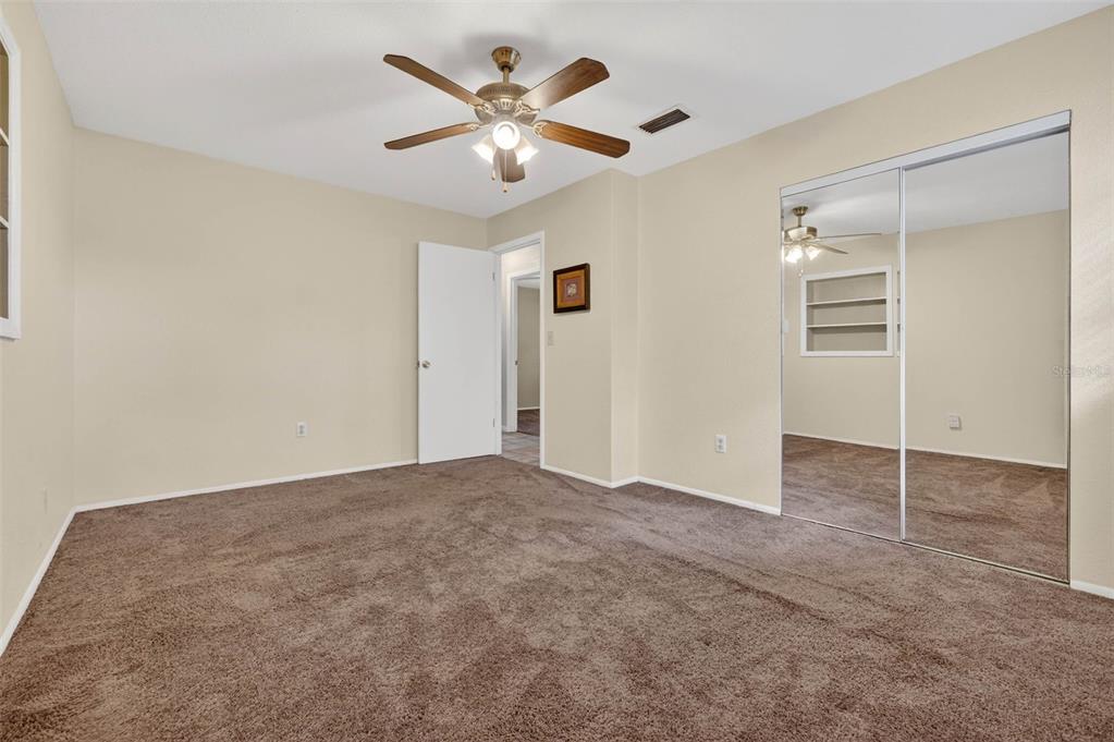 309 North 8th Street Dundee, FL 33838 - Photo 55 of 91 an empty room with closet and a ceiling fan