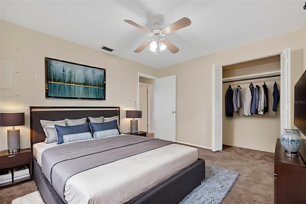 309 North 8th Street Dundee, FL 33838 - Photo 62 of 91 a bedroom with a large bed and a chandelier