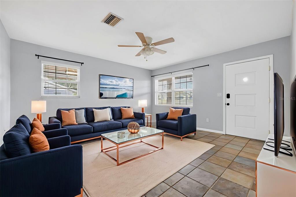 309 North 8th Street Dundee, FL 33838 - Photo 7 of 91 a living room with furniture and three windows