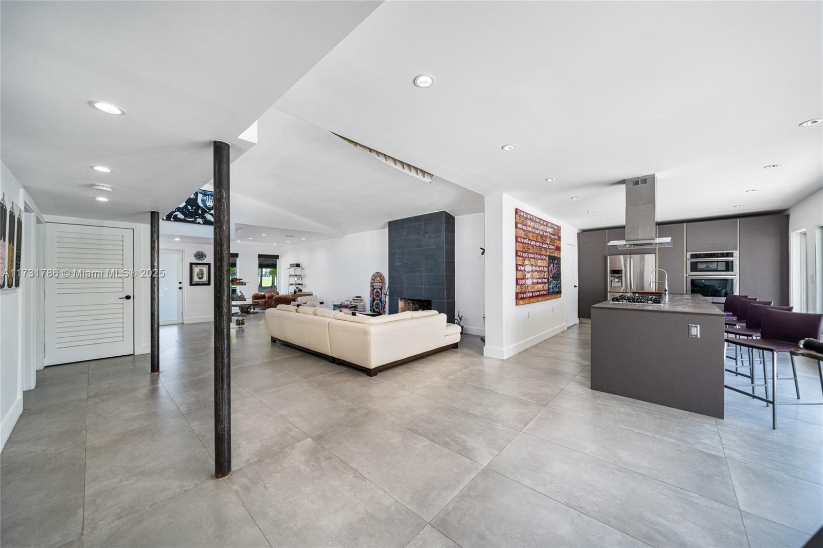 835 Fairway Drive Miami Beach, FL 33141 - Photo 11 of 39 a living room with furniture and a flat screen tv
