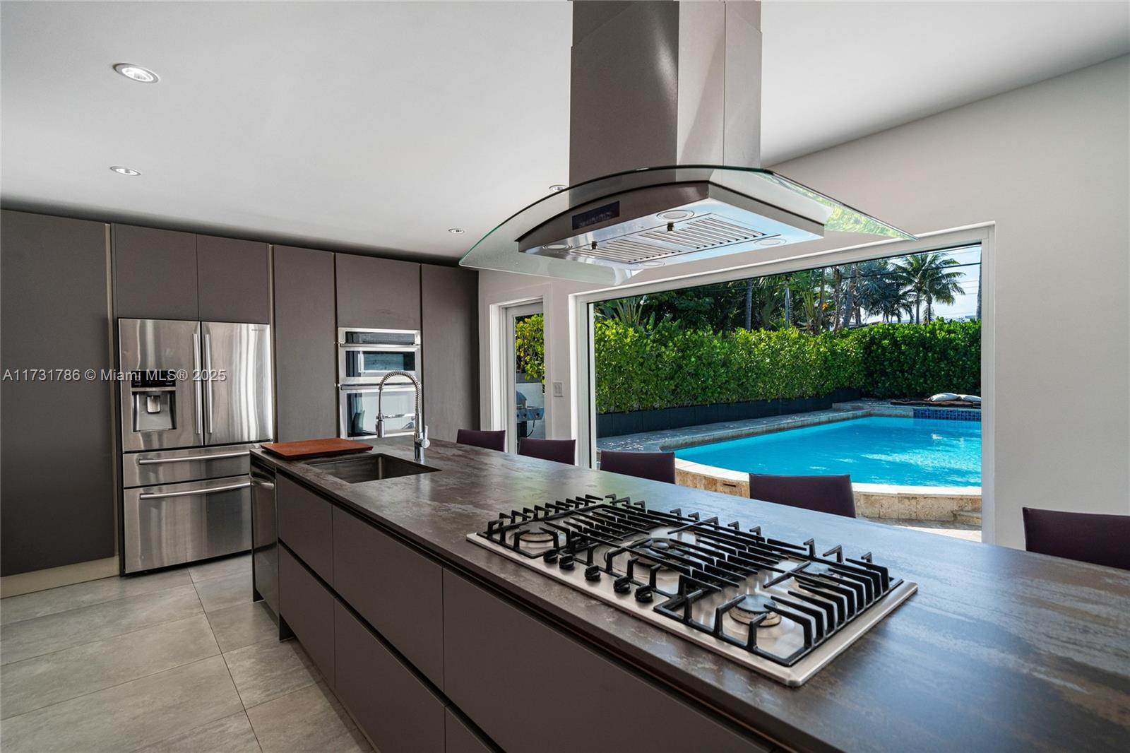 835 Fairway Drive Miami Beach, FL 33141 - Photo 13 of 39 a kitchen with sink stove and refrigerator