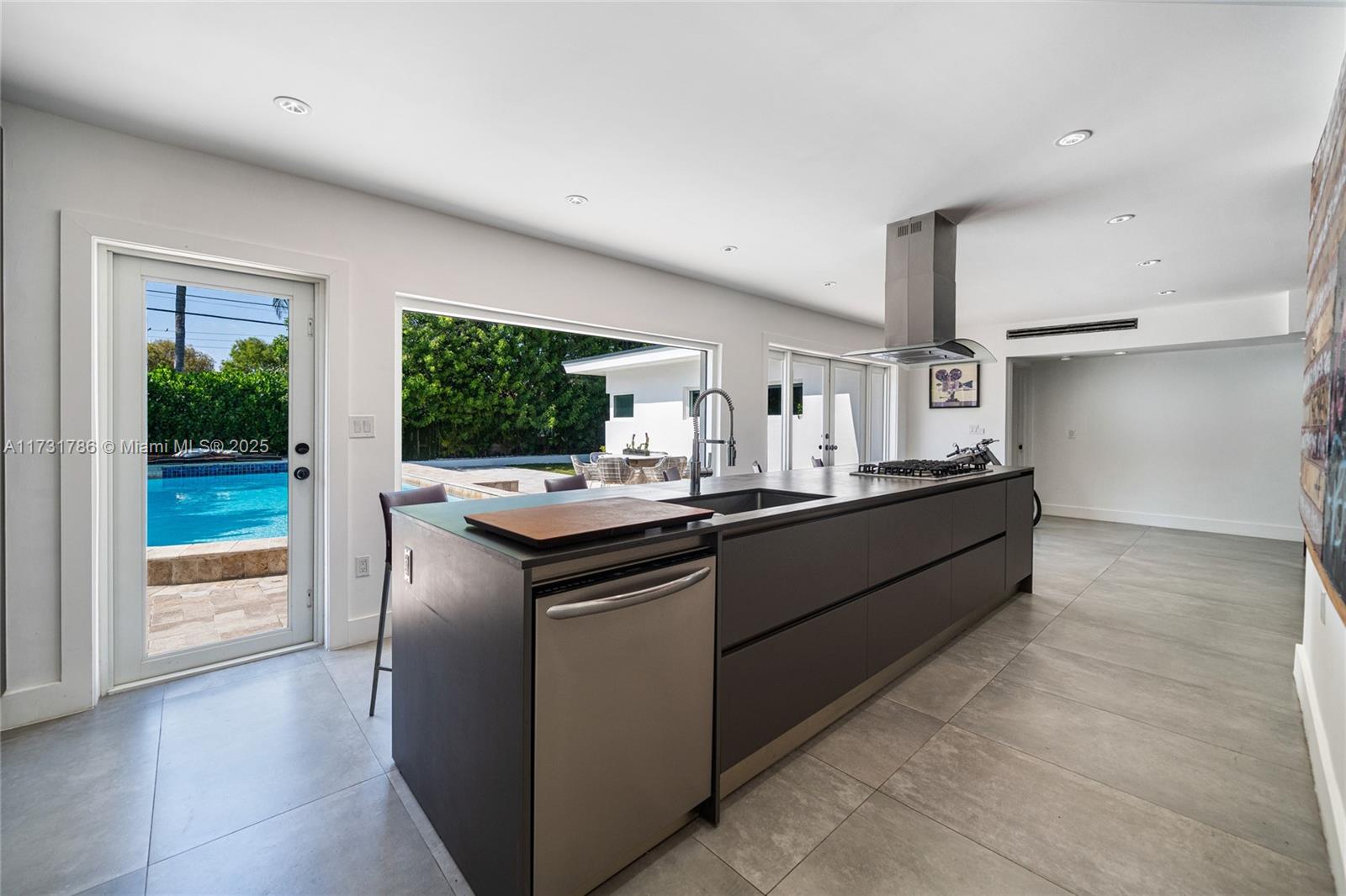 835 Fairway Drive Miami Beach, FL 33141 - Photo 15 of 39 a kitchen with stainless steel appliances kitchen island a large counter space