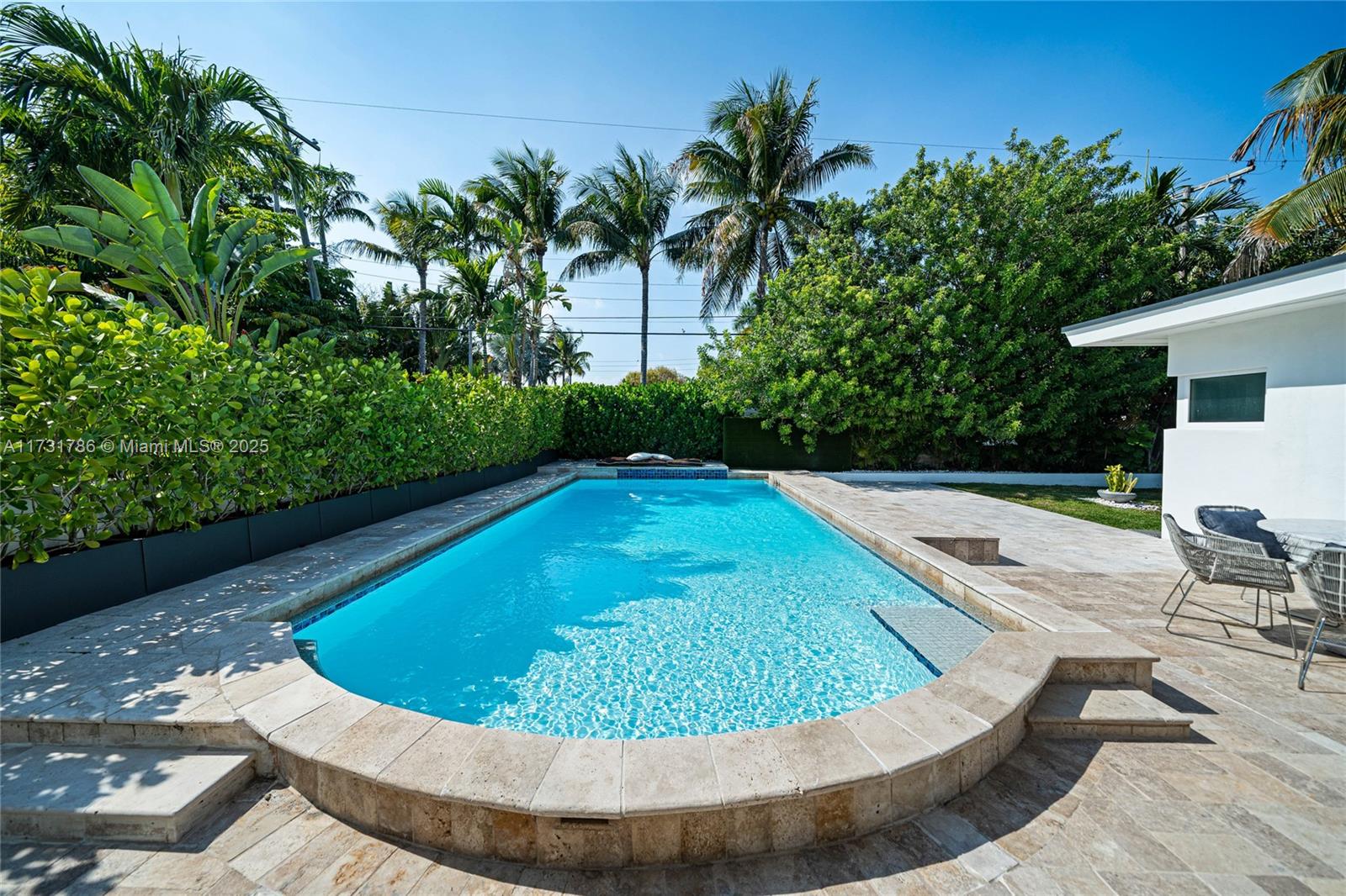 835 Fairway Drive Miami Beach, FL 33141 - Photo 17 of 39 a view of a swimming pool with a lounge chair