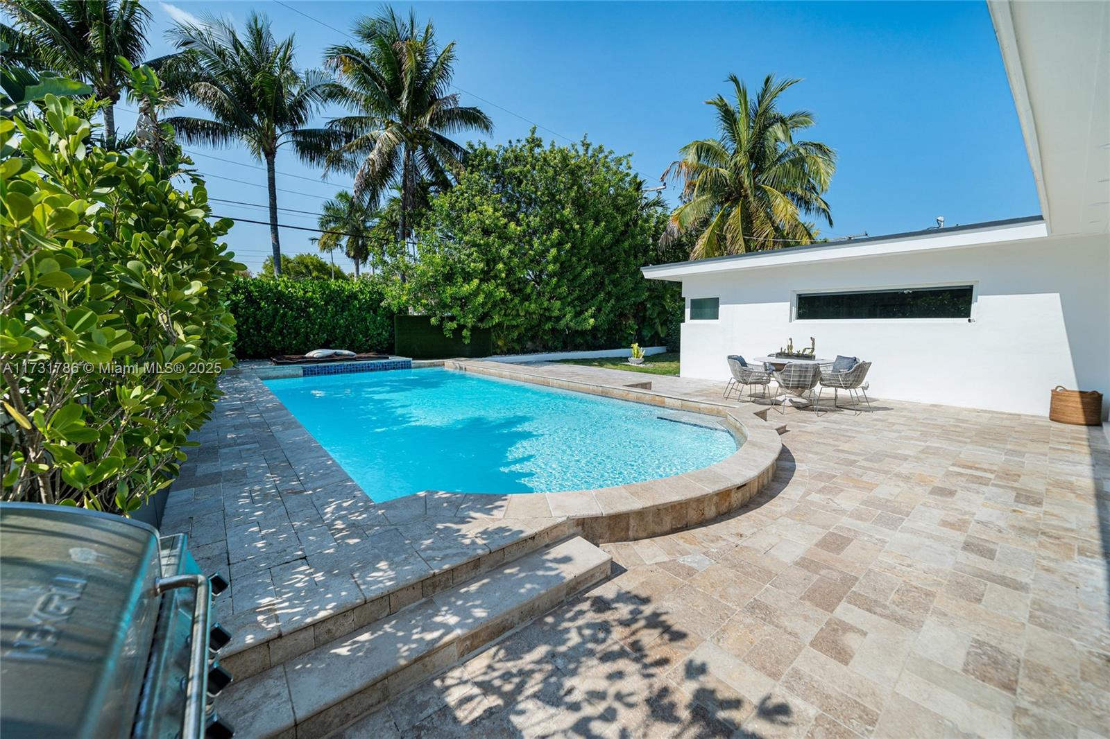 835 Fairway Drive Miami Beach, FL 33141 - Photo 18 of 39 a view of a backyard space with palm trees