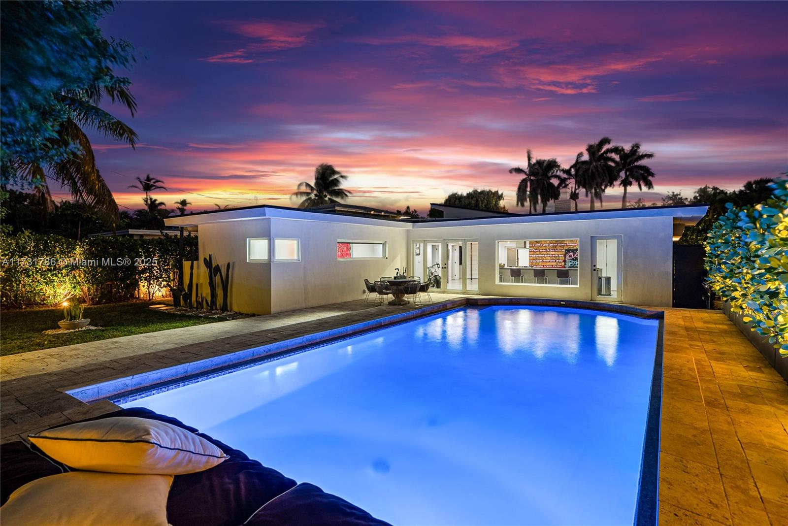 835 Fairway Drive Miami Beach, FL 33141 - Photo 2 of 39 a front view of a house with swimming pool