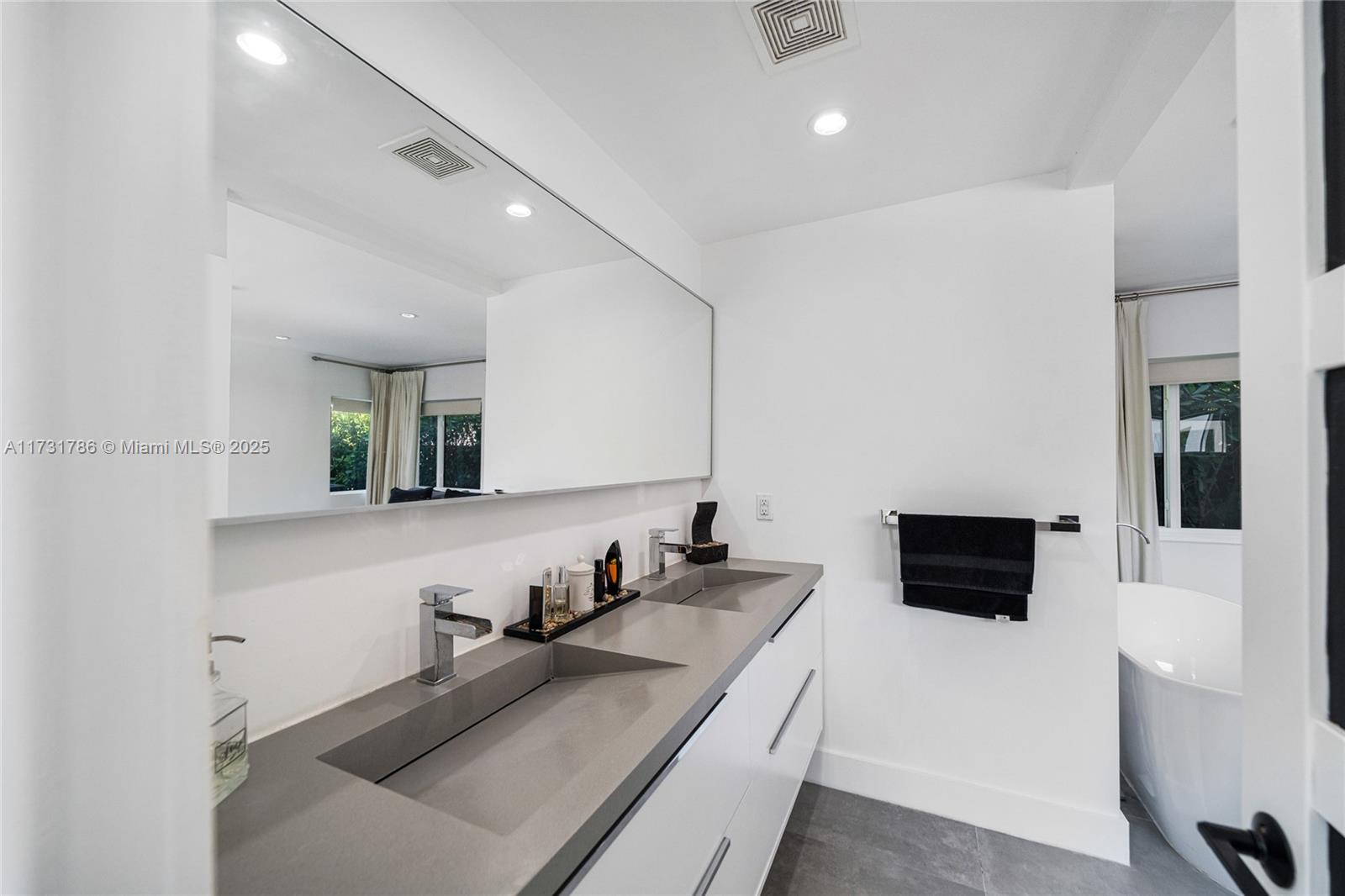 835 Fairway Drive Miami Beach, FL 33141 - Photo 25 of 39 a bathroom with a sink and a mirror