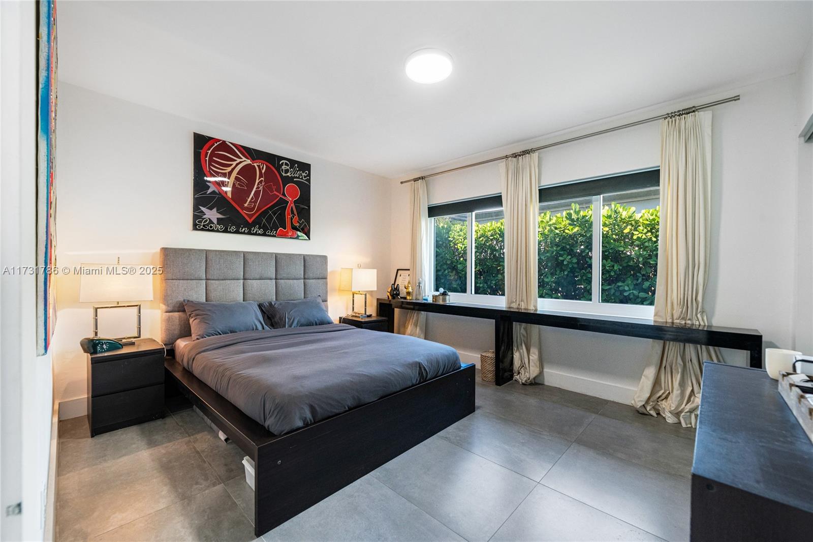 835 Fairway Drive Miami Beach, FL 33141 - Photo 29 of 39 a bedroom with a bed and a large window