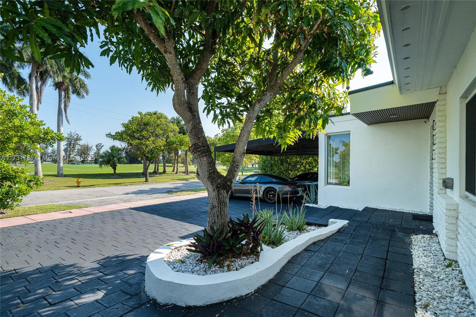 835 Fairway Drive Miami Beach, FL 33141 - Photo 33 of 39 a view of a house with a yard siting and a tree