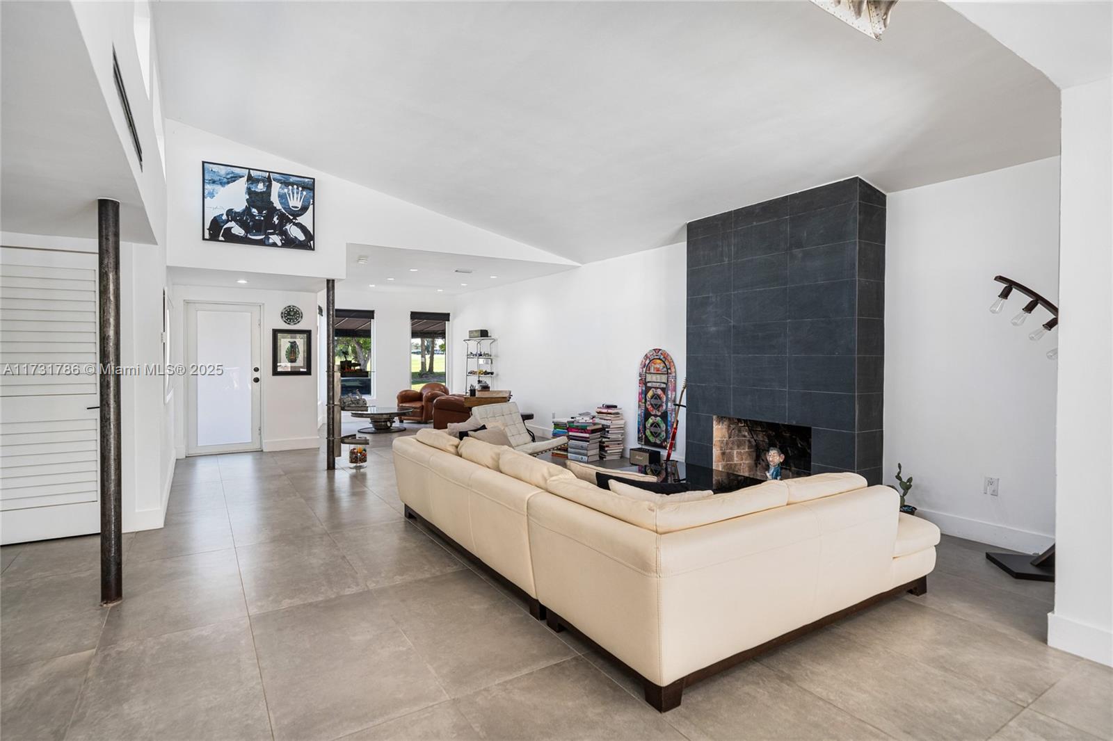 835 Fairway Drive Miami Beach, FL 33141 - Photo 6 of 39 a living room with furniture and a fireplace