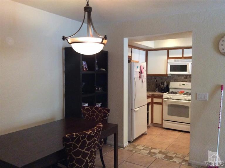1175 Fitzgerald Road, Unit E Simi Valley, CA 93065 - Photo 5 of 24 a kitchen with stainless steel appliances granite countertop a stove and a refrigerator