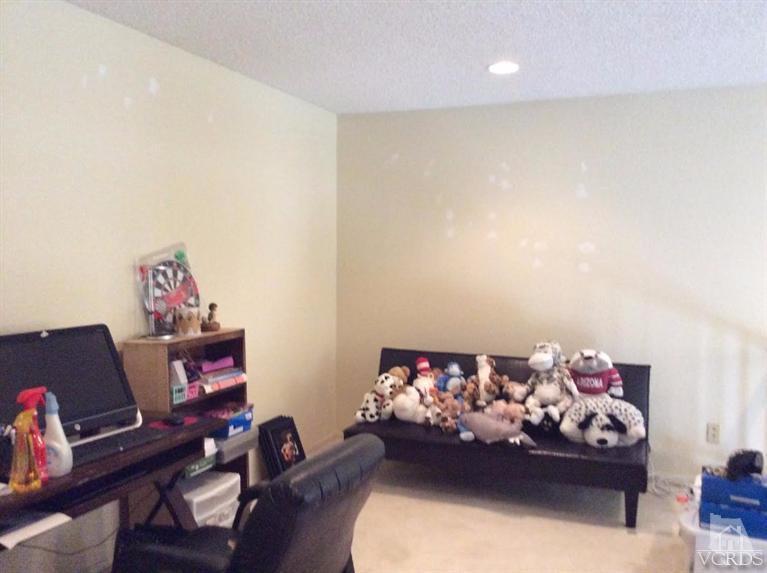 1175 Fitzgerald Road, Unit E Simi Valley, CA 93065 - Photo 9 of 24 a bed room with a bed and a couch