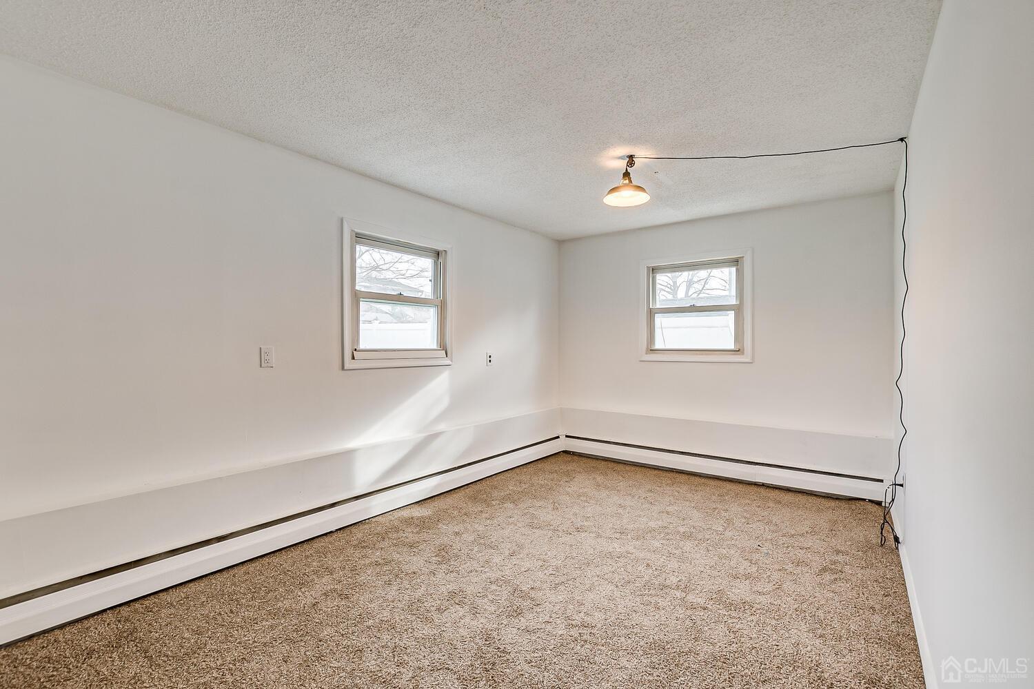 62 Hickory Road Colonia, NJ 07067 - Photo 12 of 23 an empty room with windows