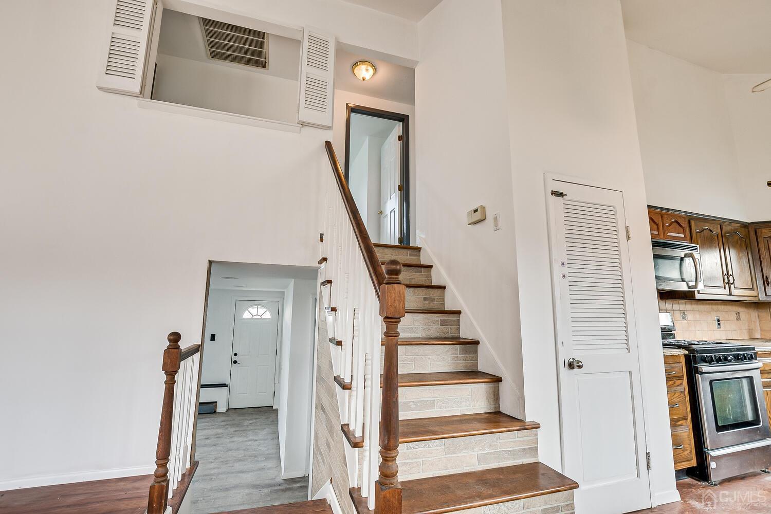 62 Hickory Road Colonia, NJ 07067 - Photo 13 of 23 a view of a hallway with wooden floor and staircase